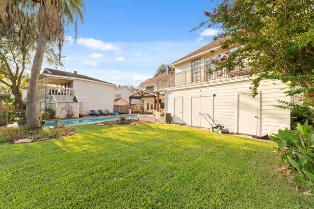 a view of a house with pool and chairs