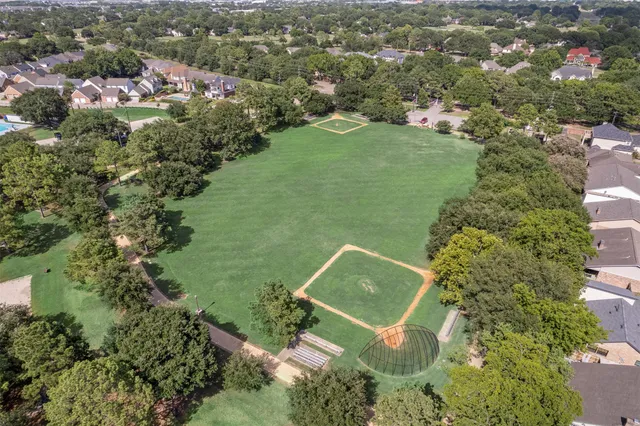 an aerial view of a houses with a big yard