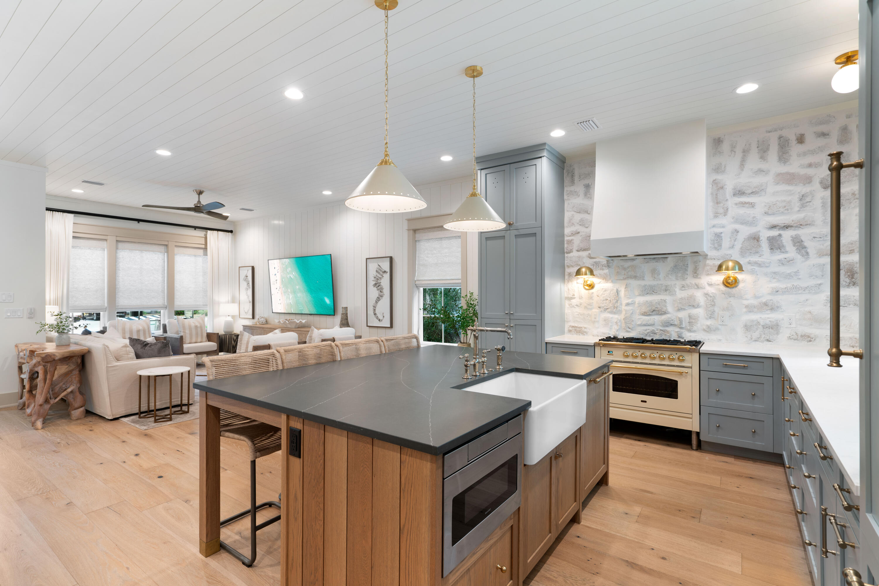 275 Clareon Dr Inlet Beach Inlet Beach, FL 32461 - Photo 15 of 76 a kitchen with a stove a sink a kitchen island with wooden cabinets and living room view