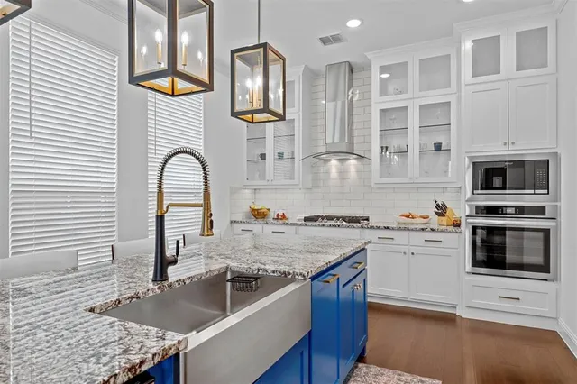 a kitchen with stainless steel appliances granite countertop a stove and a sink