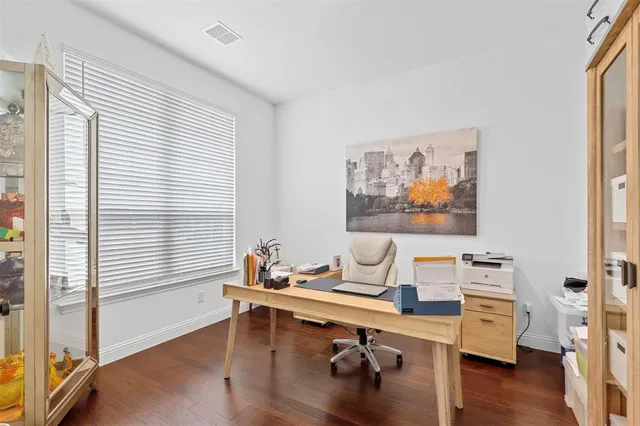 a view of a workspace with furniture and a window