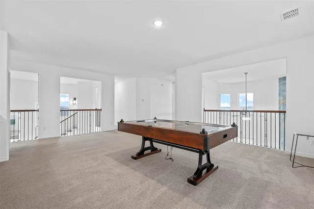 a room with furniture pool table and windows