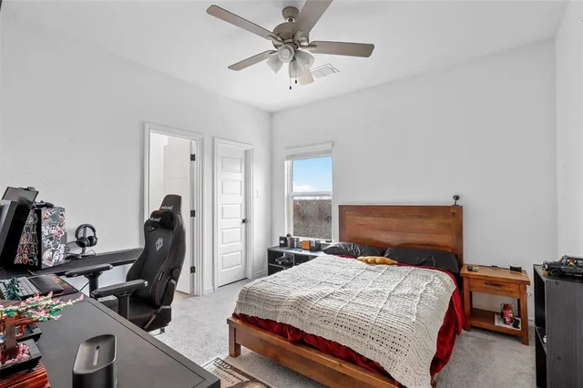 a bedroom with a bed and a desk