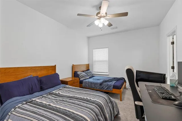 a bedroom with a bed and a couch