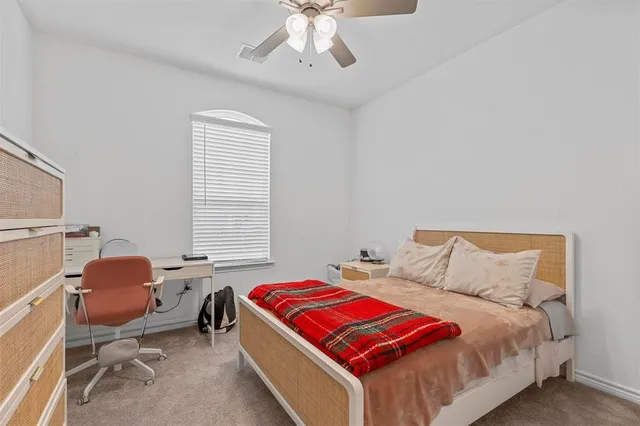 a bedroom with a bed a desk and chair