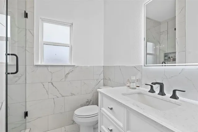 a bathroom with a sink toilet and shower