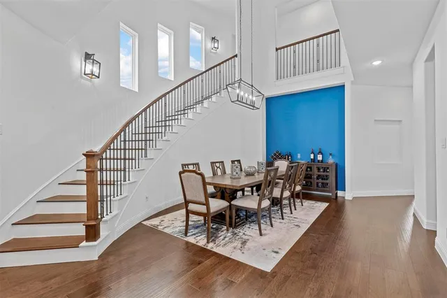 a view of a dining room with furniture wooden floor and a chandelier