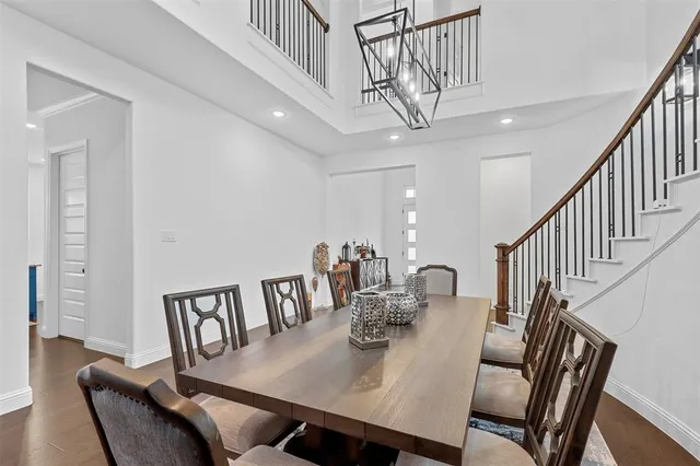 a view of a dining room with furniture a chandelier and wooden floor