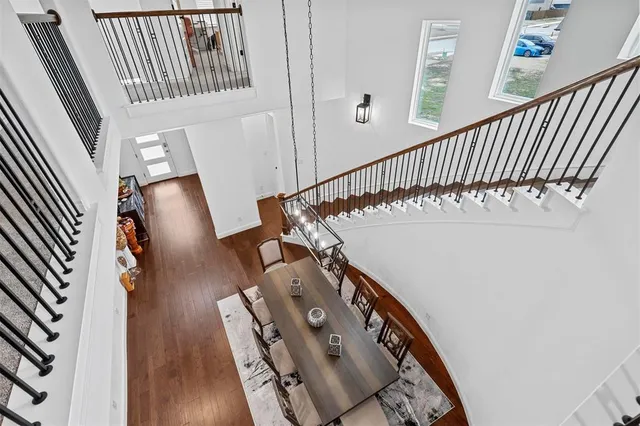 a view of stairs and hall with wooden floor