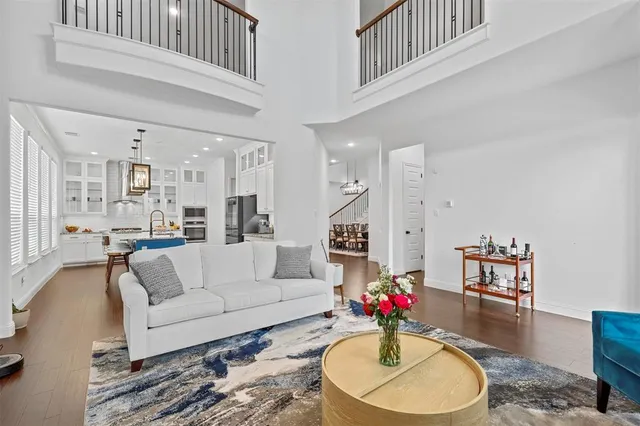 a living room with furniture and kitchen view