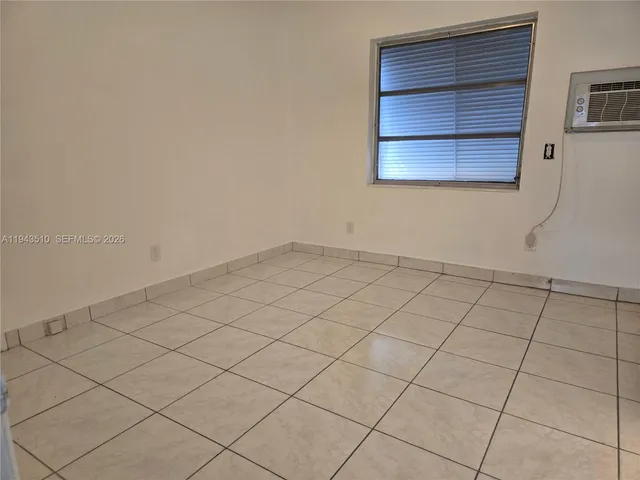 a view of an empty room and a window