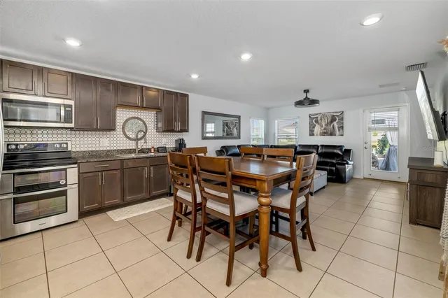 a kitchen with stainless steel appliances granite countertop a sink counter space and cabinets