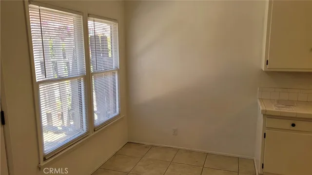 a bathroom with a sink and mirror with shower