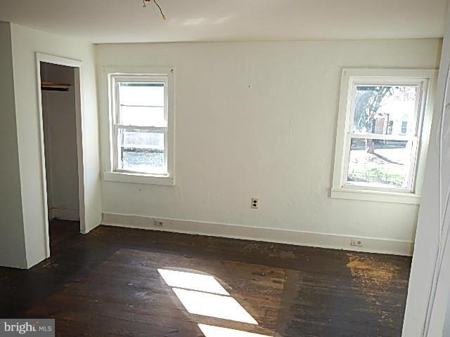 2060 Flag Marsh Road Mount Airy, MD 21771 - Photo 3 of 11 an empty room with wooden floor and windows