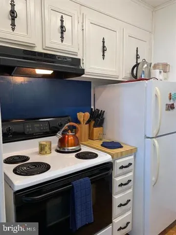a kitchen with a stove and refrigerator