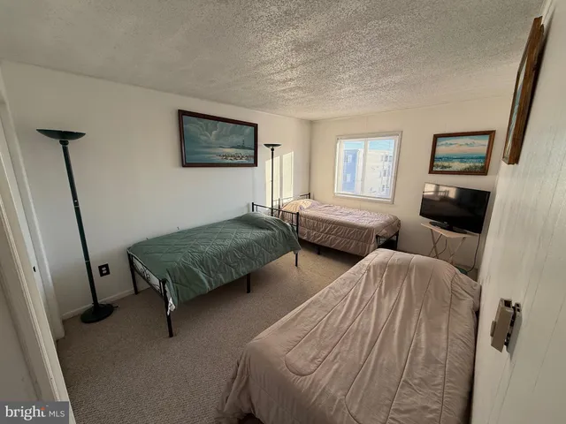 a bedroom with two beds and a window