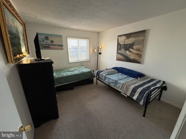 a bedroom with bed and window