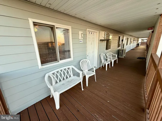 a view of a room with wooden floor and furniture