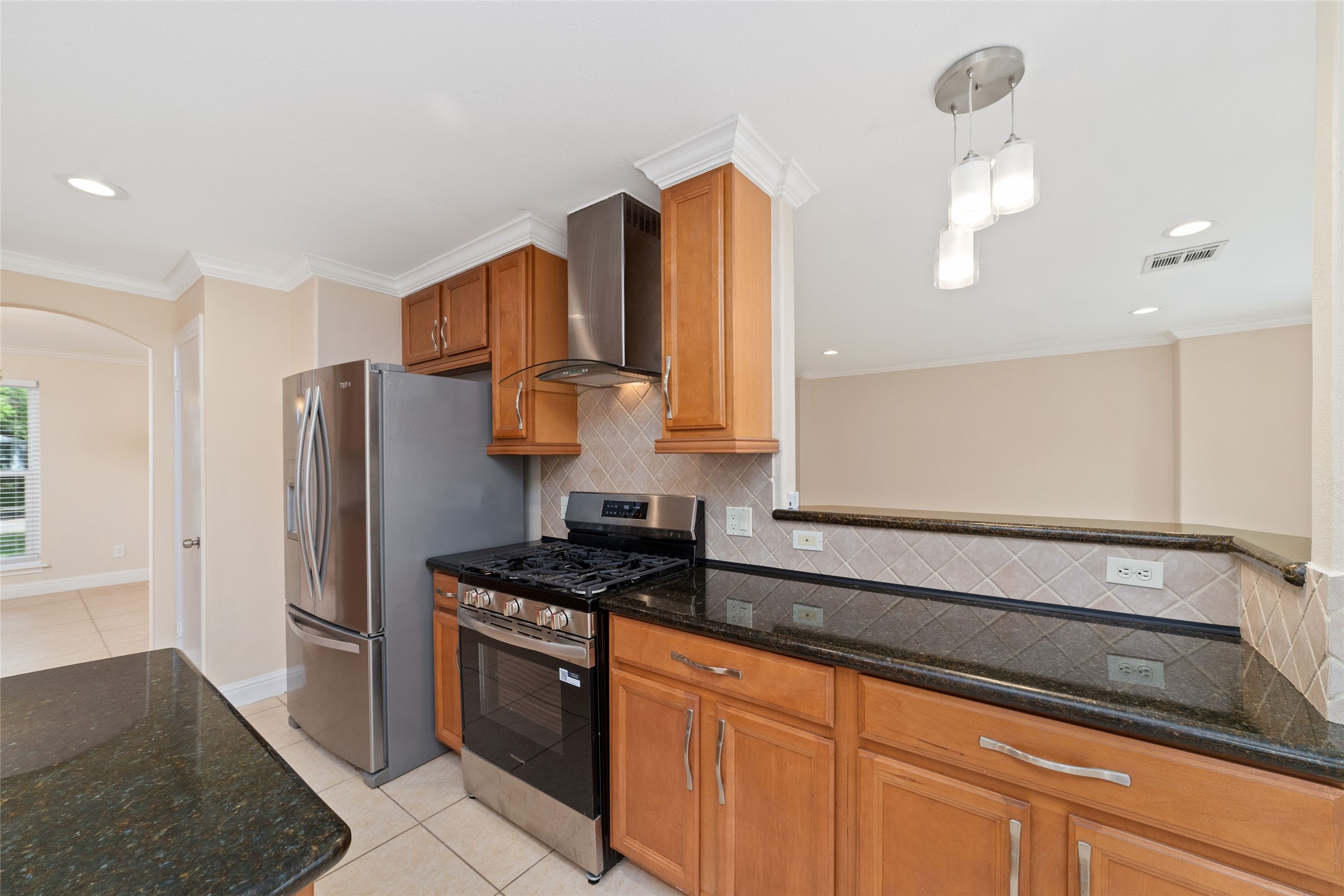 5643 Cheena Drive Houston, TX 77096 - Photo 11 of 32 a kitchen with stainless steel appliances granite countertop a stove a refrigerator and a sink