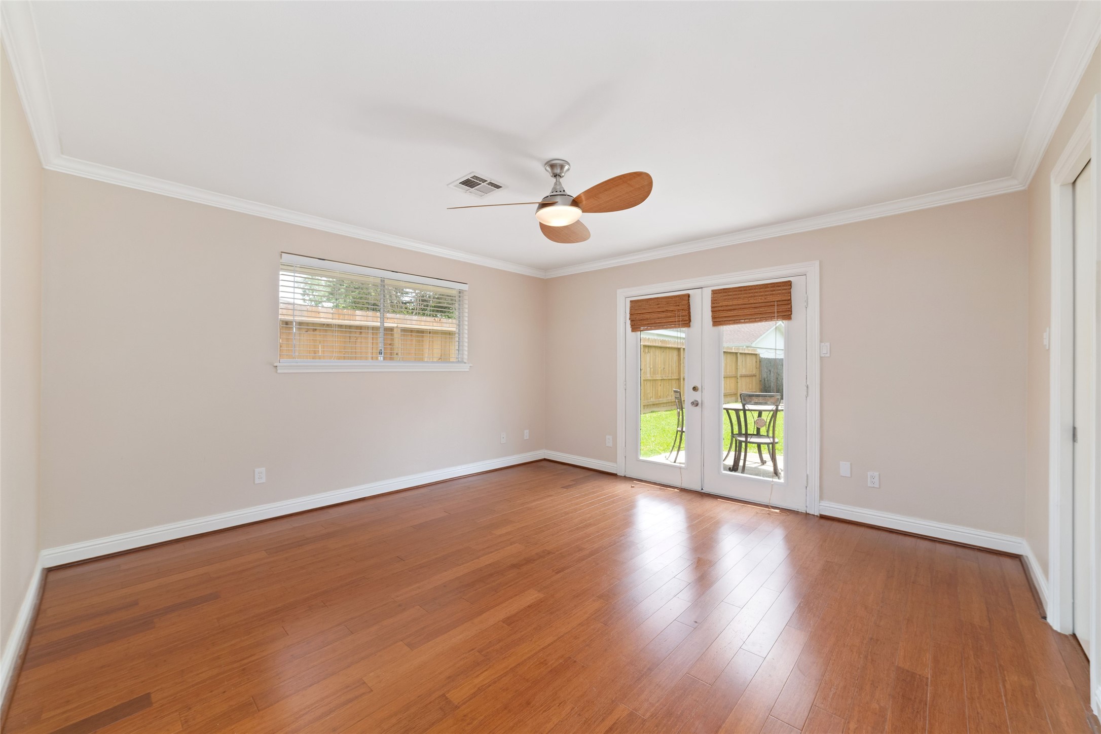 5643 Cheena Drive Houston, TX 77096 - Photo 18 of 32 an empty room with wooden floor and windows