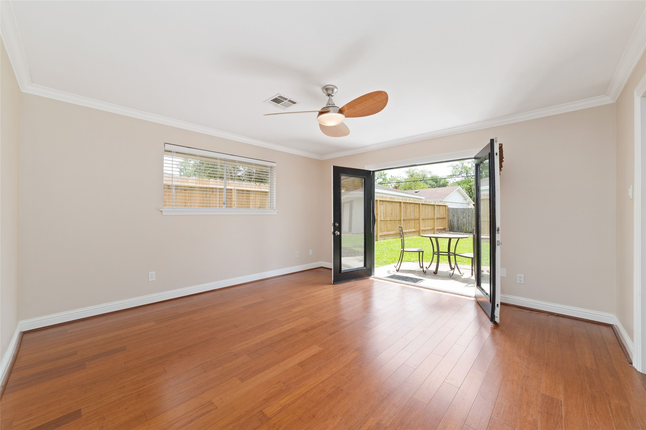 5643 Cheena Drive Houston, TX 77096 - Photo 19 of 32 a view of an empty room with a window and wooden floor
