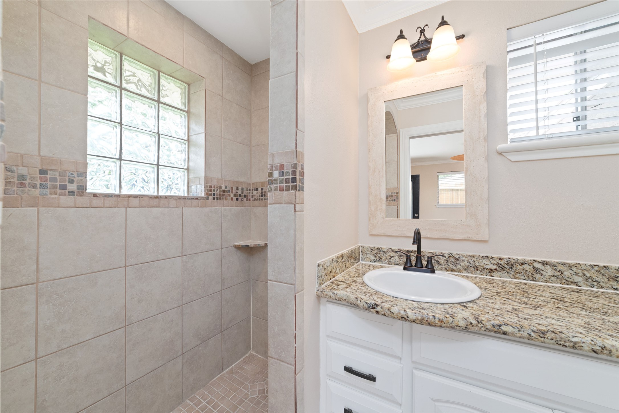 5643 Cheena Drive Houston, TX 77096 - Photo 21 of 32 a sink vanity and a mirror