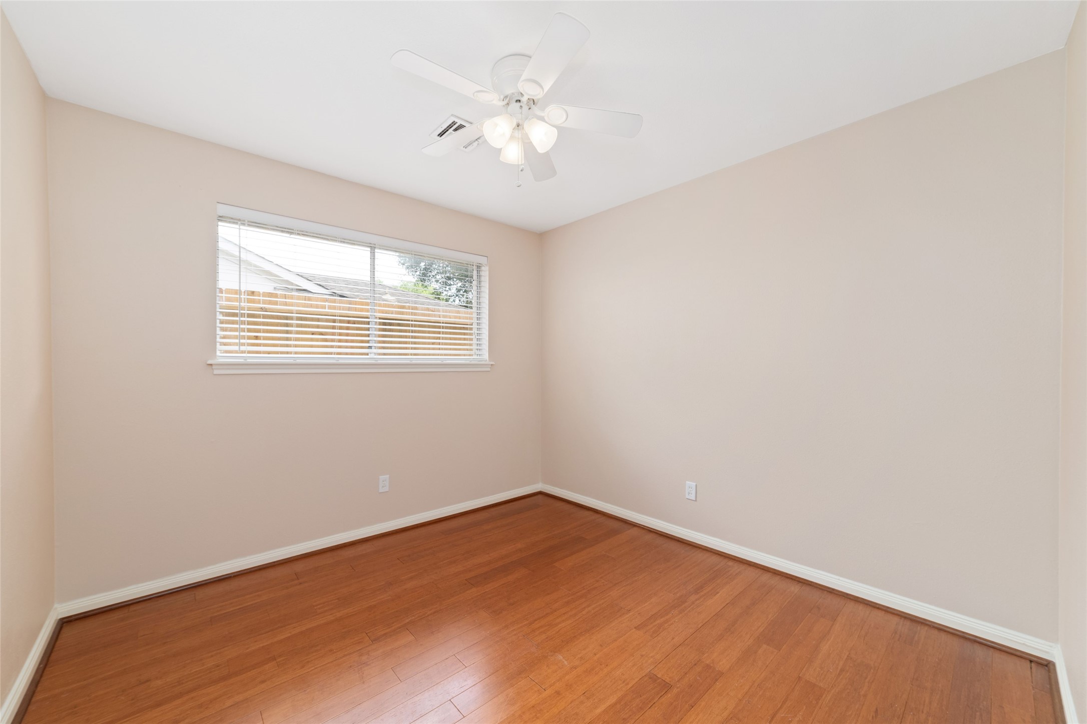 5643 Cheena Drive Houston, TX 77096 - Photo 25 of 32 an empty room with a chandelier fan and windows