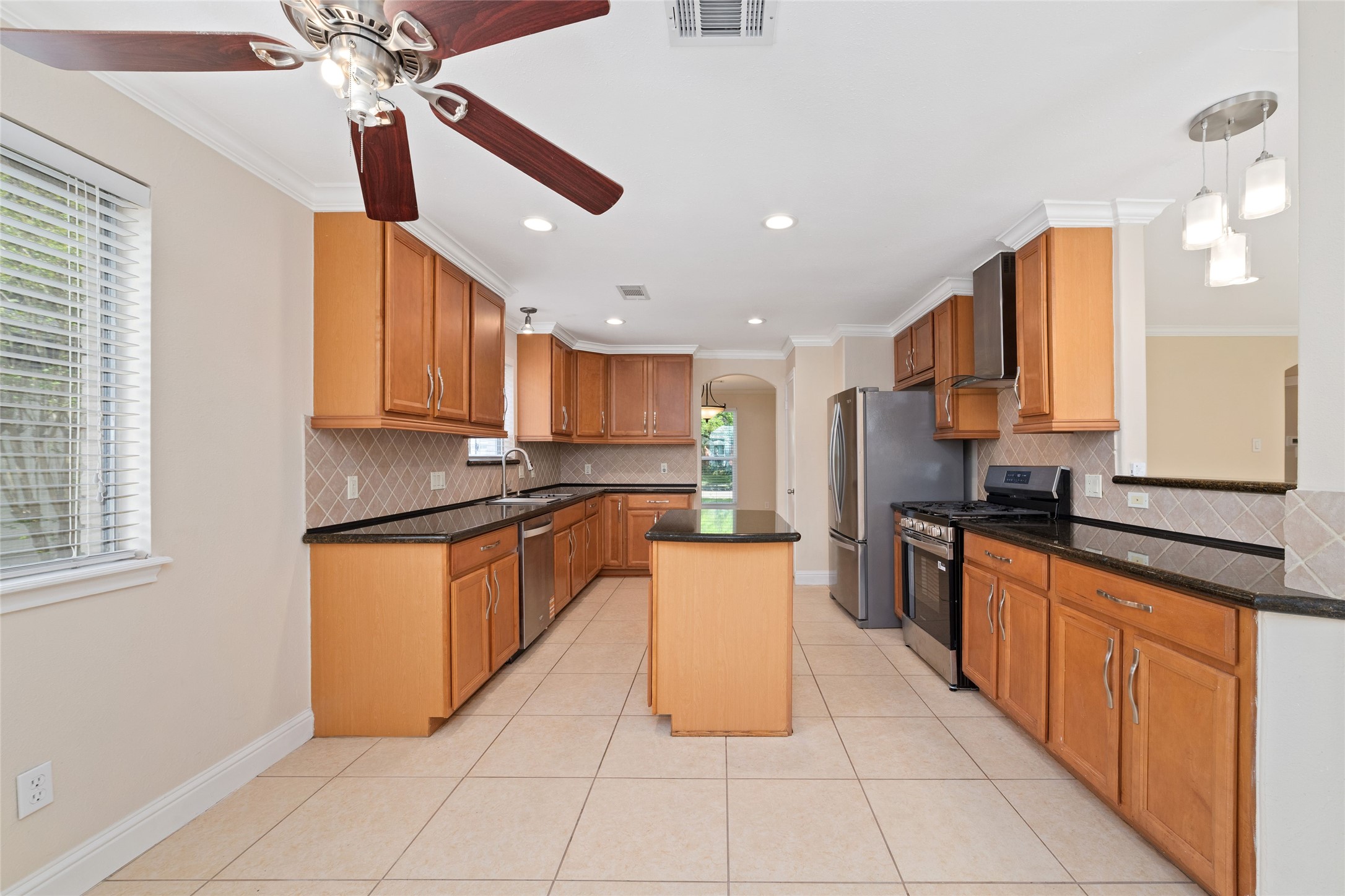 5643 Cheena Drive Houston, TX 77096 - Photo 8 of 32 a large kitchen with stainless steel appliances cabinets a sink and a counter top space