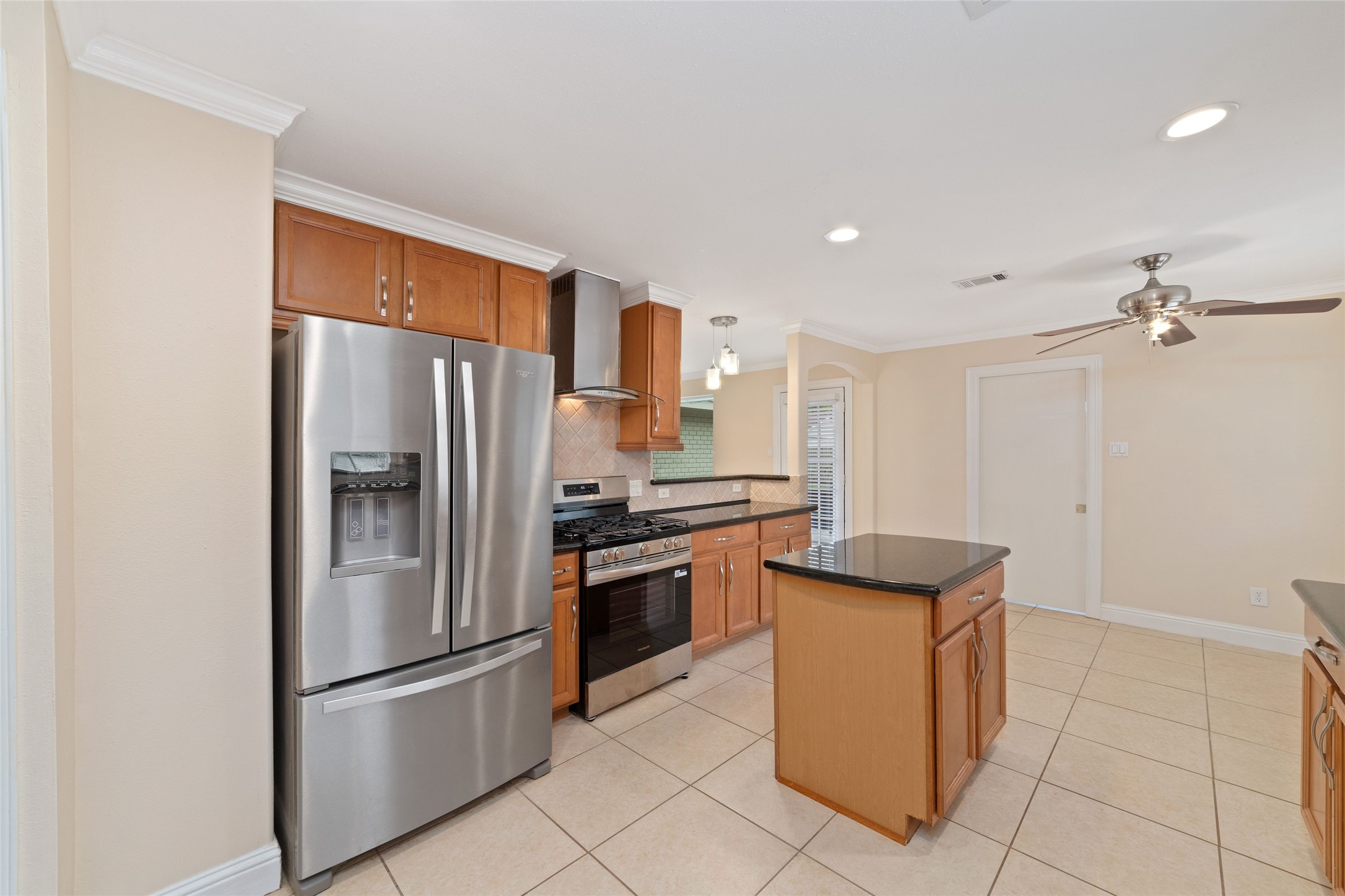 5643 Cheena Drive Houston, TX 77096 - Photo 10 of 32 a kitchen with granite countertop stainless steel appliances and a refrigerator