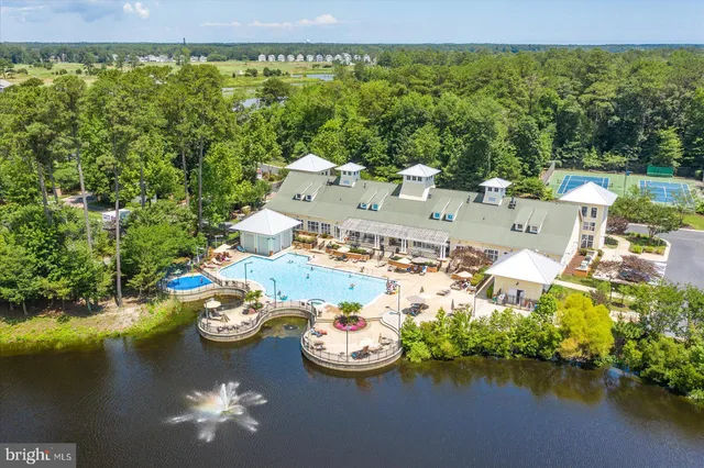 an aerial view of a house with swimming pool and lake view