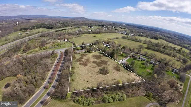 an aerial view of a house with a mountain