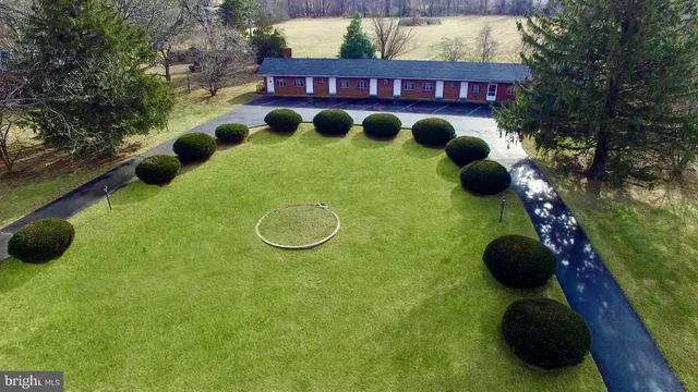 a view of swimming pool outdoor seating and yard in front of the house