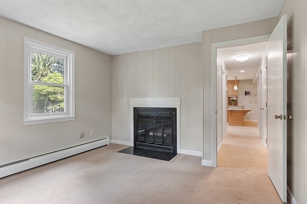 10 Hickory Drive Worcester, MA 01609 - Photo 6 of 34 a view of an empty room with a fireplace and a window