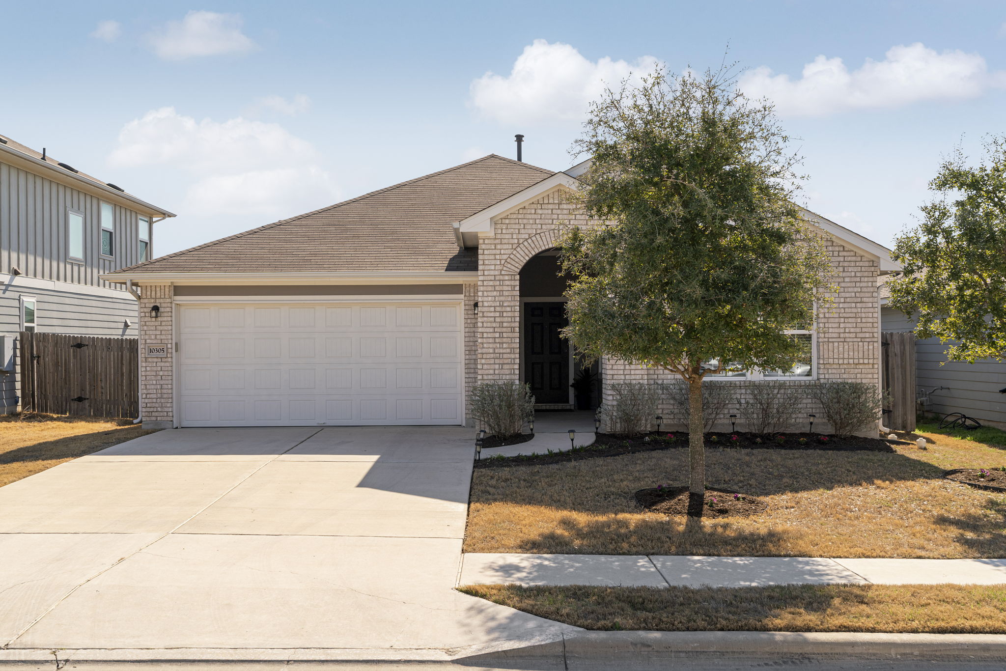 10305 Bankhead Drive Austin, TX 78747 - Photo 4 of 40 a front view of a house with a yard