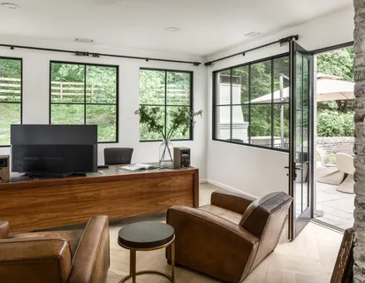 a living room with furniture tv and a large window