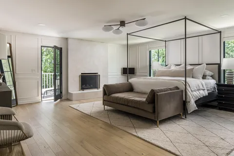 a bedroom with a bed window and a fireplace