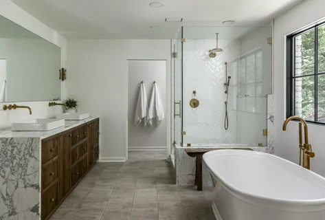 a spacious bathroom with a double vanity sink a mirror and a bathtub
