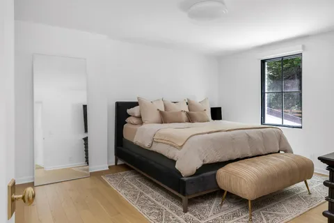 a bedroom with furniture and a window