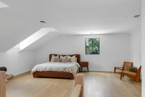 a bedroom with a bed and a couch