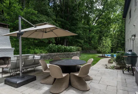 a view of backyard of house with seating space