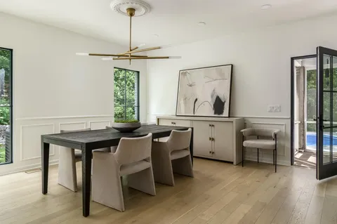 a kitchen with a table chairs refrigerator and sink