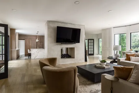 a living room with furniture a flat screen tv and a fireplace
