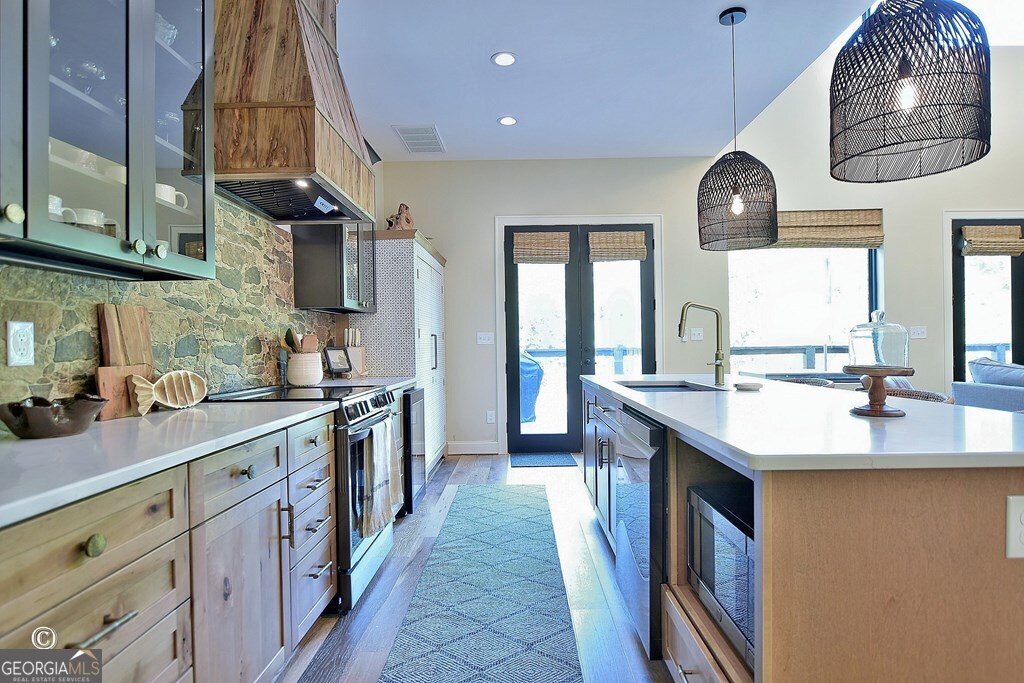 299 Coldivees Road Hamilton, GA 31811 - Photo 11 of 46 a kitchen with stainless steel appliances a sink stove and cabinets