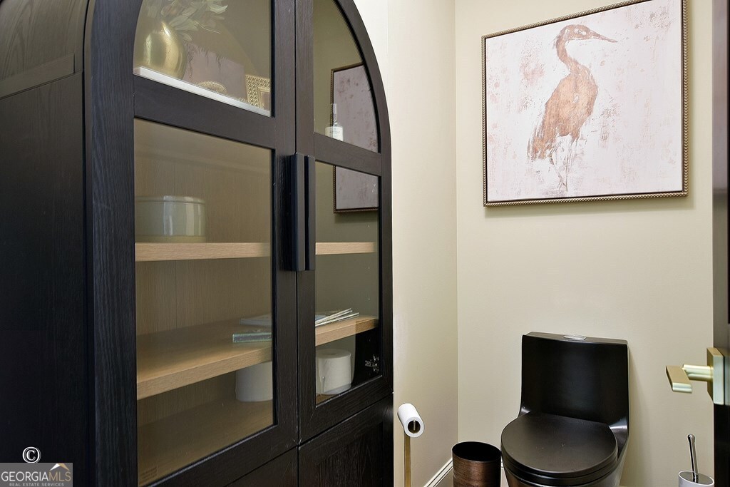 299 Coldivees Road Hamilton, GA 31811 - Photo 20 of 46 a bathroom with a toilet and a painting on the wall