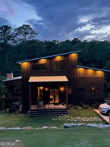 a living room with furniture kitchen view and a table
