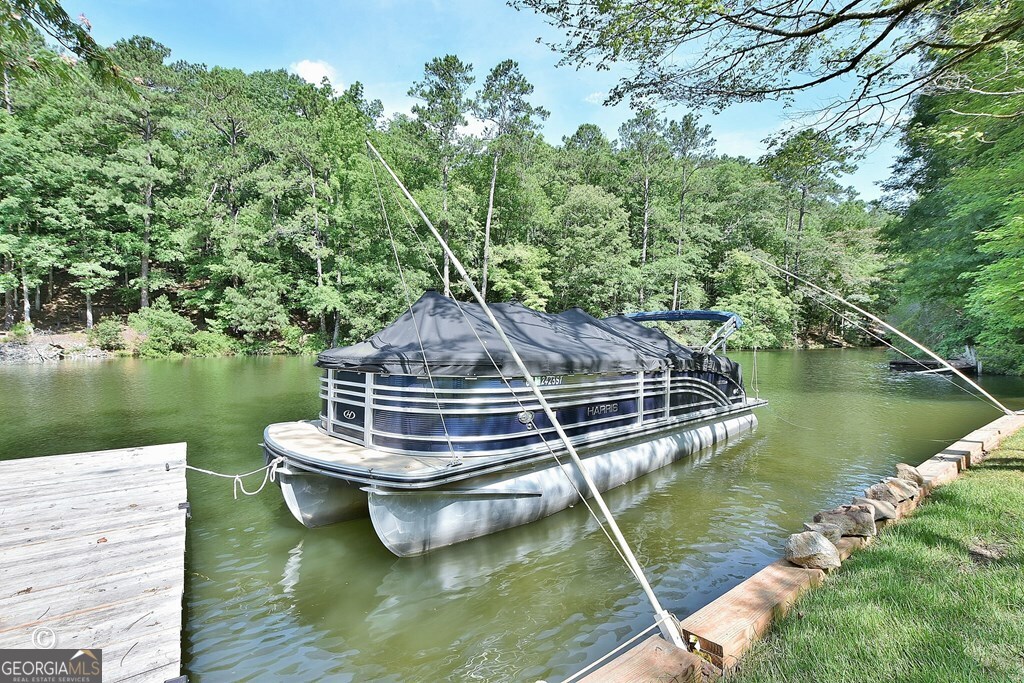 299 Coldivees Road Hamilton, GA 31811 - Photo 46 of 46 a view of a lake with wooden stairs and lake view