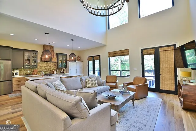 a kitchen with stainless steel appliances granite countertop a sink a stove and cabinets