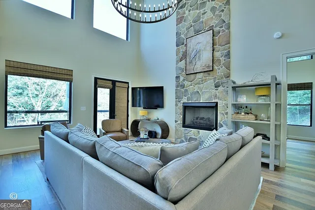 a dining room with furniture a chandelier and wooden floor