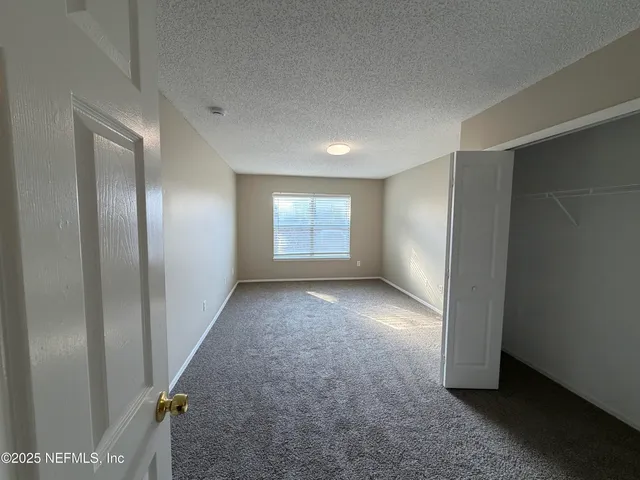 a view of workspace and window in an empty room
