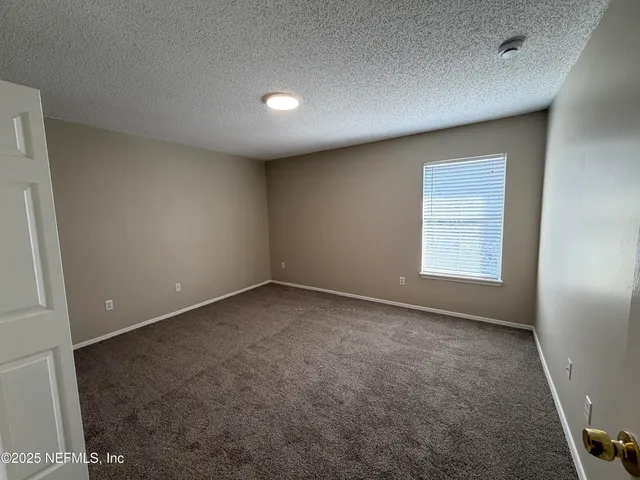 an empty room with a empty space and windows